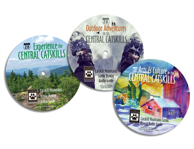 three CDs with colorful graphics